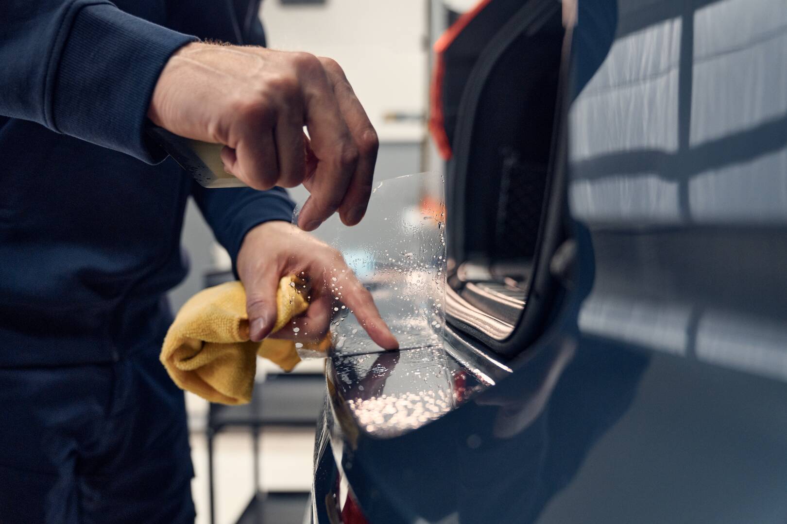 Car technician applying paint protection