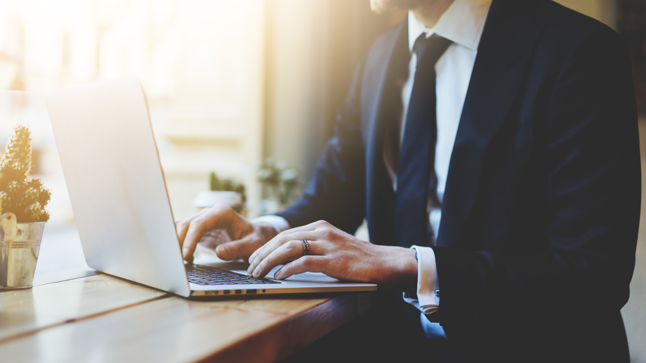 Businessman typing on laptop