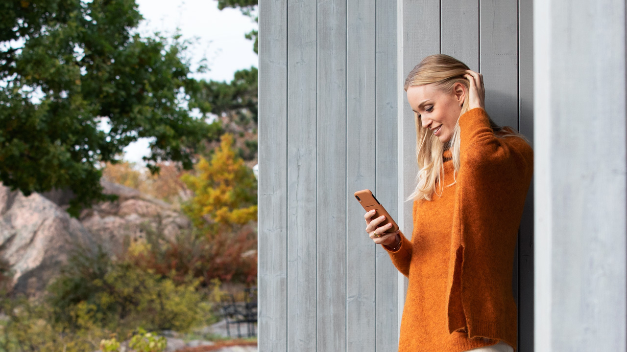 Woman outside with phone in fall