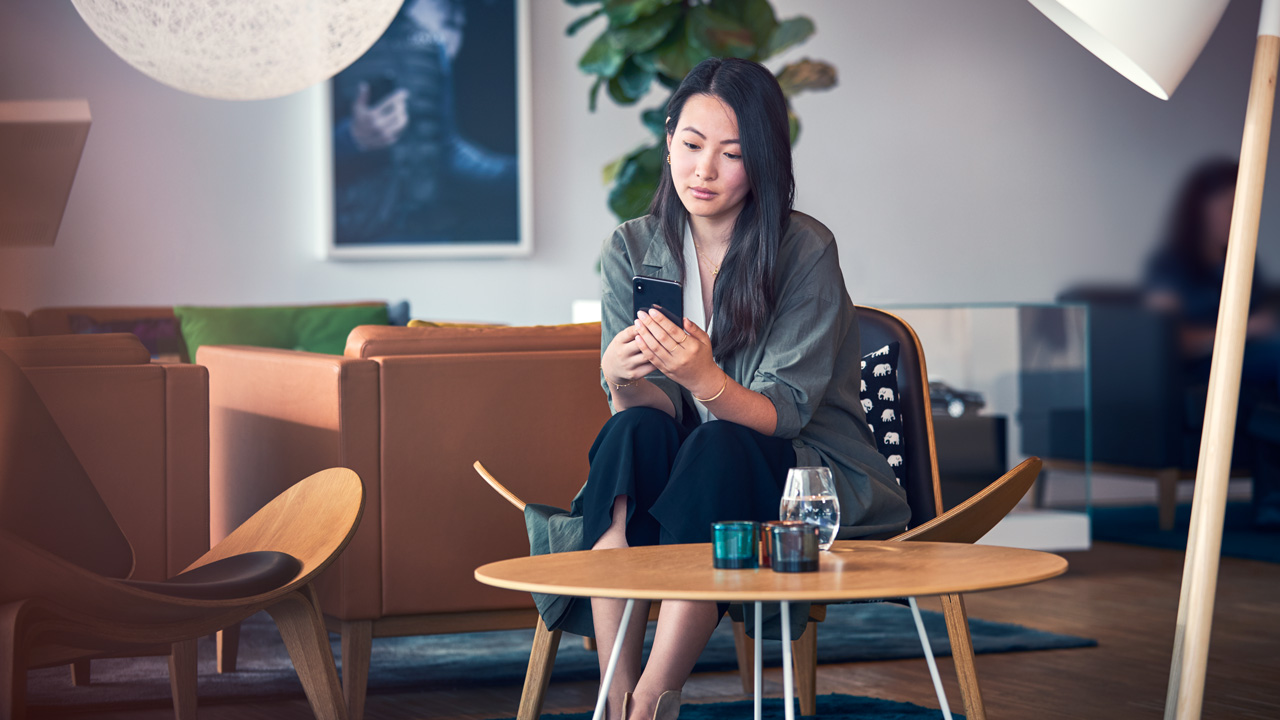 Woman waiting in customer service lounge on phone