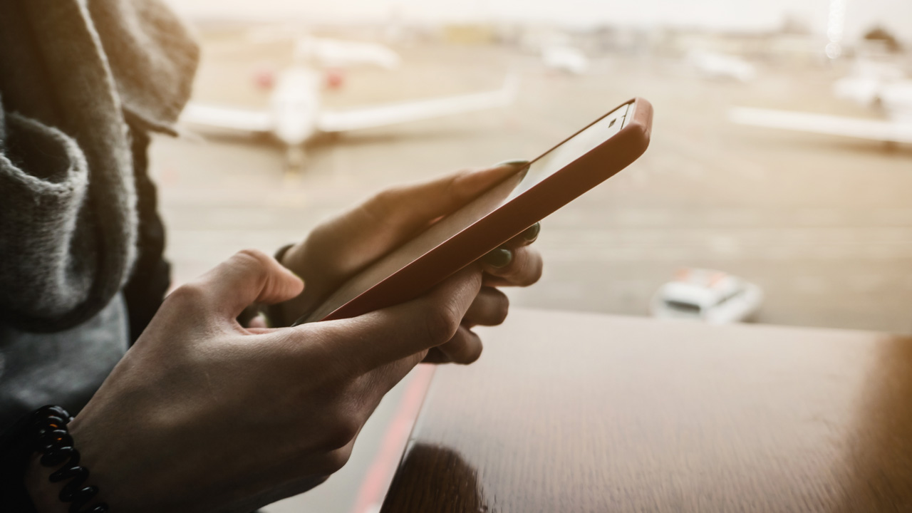 Woman on mobile phone at airport