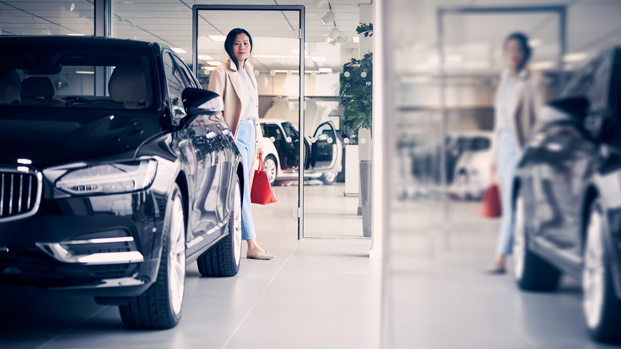 Woman in dealership with red bag