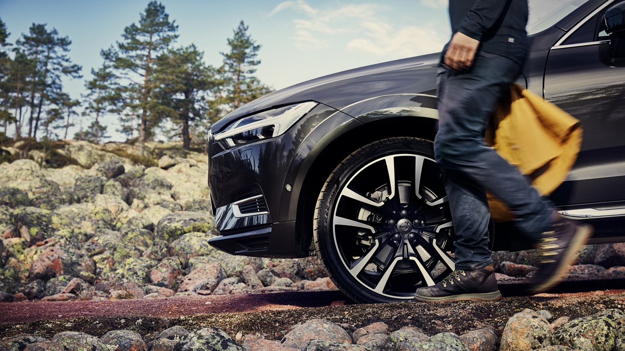 Man walking by tires on terrain