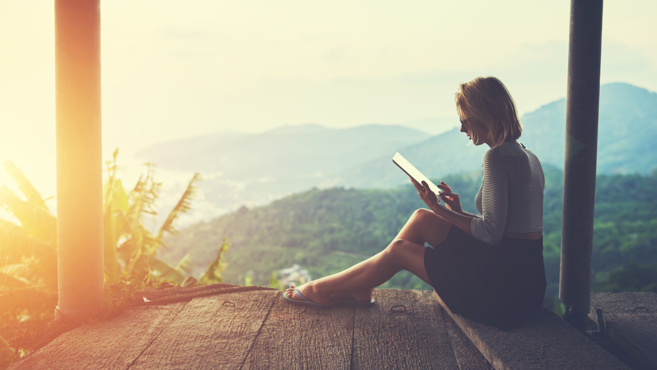 Woman on tablet at dusk